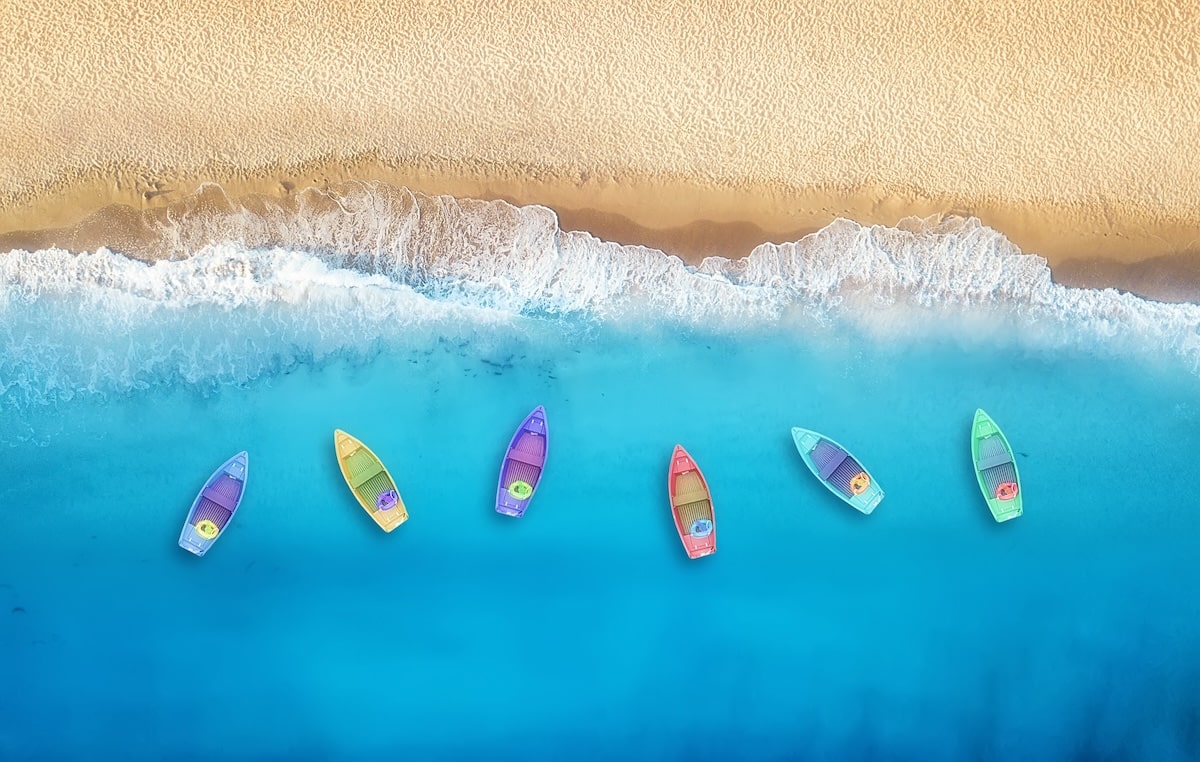 Boats from air. Aerial view on sea in Turkey. Summer seascape with clear water and sandy beach in sunny day. Top view of boats from drone. Summer seascape from air. Travel - image